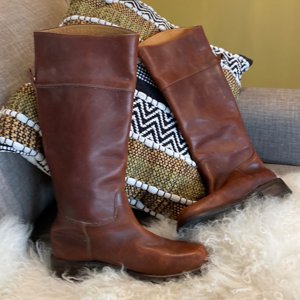 Distressed tobacco brown leather riding boots.
